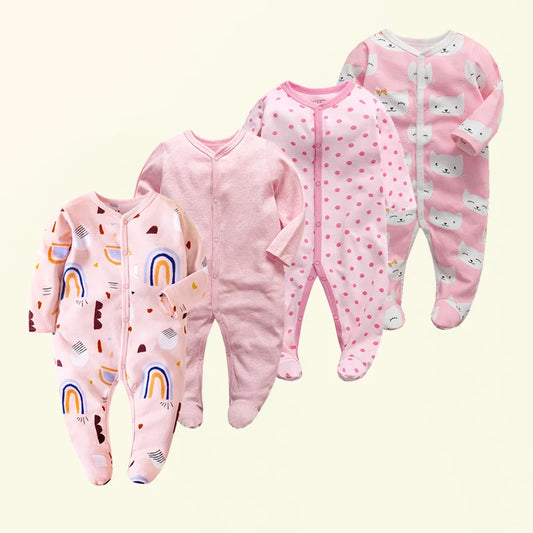 Four pink baby onesies with different patterns on a light beige background